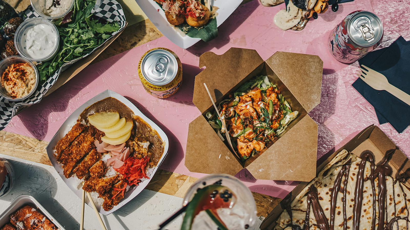 Takeawaymat, snacks och läsk på ett bord – exempel på processad och ultraprocessad mat som kan innehålla livsmedelstillsatser.